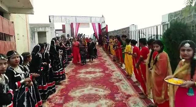 Students in traditional dress welcome guests